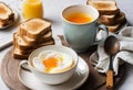 A close-up of a soft boiled egg in a cup with a slice of toast on the side Royalty Free Stock Photo