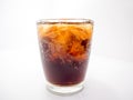 Close-up, soft drink and ice in a curved clear glass Royalty Free Stock Photo