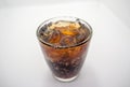 Close-up, soft drink and ice in a curved clear glass Royalty Free Stock Photo