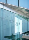 Close-up soft light pattern glass wall facade exterior architecture building reflection blue sky clean environment background. Royalty Free Stock Photo