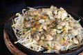 Close up soft oyster omelette with bean sprouts in black hot pan with chilli sauce Royalty Free Stock Photo