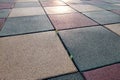 Close up of soft rubber tiles for covering at outdoor gym of stadium at preschool yard