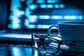 Closeup of a software developers screen showing complex code with glasses and a cup of coffee in the foreground