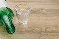 Close up of soju bottle with glass on the wooden table