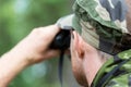 Close up of soldier or hunter with binocular