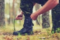 Close up of soldier tying bootlaces in forest Royalty Free Stock Photo