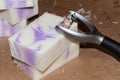 Close-up of some bars of freshly made natural handmade soap with lavender essential oil. Tool for making soap Royalty Free Stock Photo