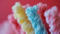 a close up of some colored cotton candy sticks against a red background