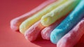 a close up of some colored cotton candy sticks against a red background