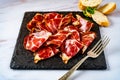 Close-up of some delicious pork bondiola fetas on a marble table. High view