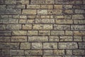 Close up of some fragment of a yellowed cobblestone walkway. Old stone paving. Ancient road construction texture Royalty Free Stock Photo