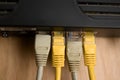 Close-up of some rj45 ethernet type cables connected to a black router Royalty Free Stock Photo