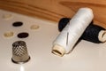 Close-up of some spools of black and white thread and a thimble. Royalty Free Stock Photo