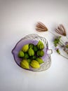 Close up some of tomatillo fruit on a purple bowl