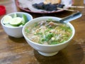 Close up of Soto Daging, meat soup, an Indonesian traditional soup on wooden table