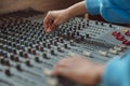 Close-up sound engineer hands using mixing board, software to create new song in professional music studio Royalty Free Stock Photo