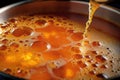 close-up of soup bubbles forming while stirring