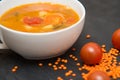 close up on soup with tomato, lentil and potato, rustical background, top view Royalty Free Stock Photo