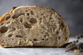 Close up sourdough artisan homemade bread sliced in halfs on dark background.