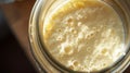 Close up of sourdough starter levain leaven with thick texture and bubbles in glass jar with a lid. Homemade artisan bread baking Royalty Free Stock Photo