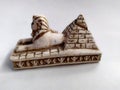 Close-up on a souvenir sphinx and pyramids from Egypt on a white background