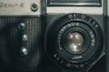 Close-up of the Soviet manual lens Industar 50-2 on a film camera. Black background, copy space, deep shadows Royalty Free Stock Photo