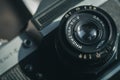 Close-up of the Soviet manual lens Industar 50-2 on a film camera Zenit-E. Black background, copy space, deep shadows Royalty Free Stock Photo