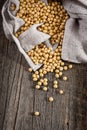 Close-up of soybean on wood background in jute sack.