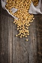Close-up of soybean on wood background in jute sack.
