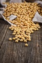 Close-up of soybean on wood background in jute sack.