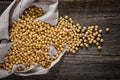 Close-up of soybean on wood background in jute sack.