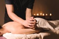 Close-up Spa massage low angle. male massage therapist doing a back and shoulder massage to a young girl with her elbows