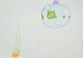 Close up. A spaceship flies in space, planet Earth. Child`s drawing. Creative activities with children 4-5 years old