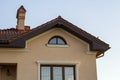 Close up of spacious brown shingle roof of modern luxurious expensive residential cottage house with three chimneys, big windows Royalty Free Stock Photo