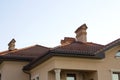 Close up of spacious brown shingle roof of modern luxurious expensive residential cottage house with three chimneys, big windows Royalty Free Stock Photo