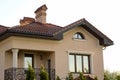 Close up of spacious brown shingle roof of modern luxurious expensive residential cottage house with three chimneys, big windows