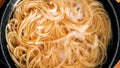 Close-up of spaghetti pasta In boiling hot water in steel pan. Preparation for making Al Dente Spaghetti