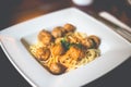 Close-up of spaghetti pasta with meatballs and tomato sauce in a white plate on the table Royalty Free Stock Photo