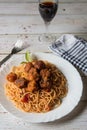 Top view of spaghetti pasta and meatballs in a plate along with condiments Royalty Free Stock Photo