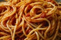 a close up of spaghetti with sauce