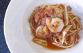 Close up of spaghetti with shrimps in tomato sauce, serving on white plate. top view from above Royalty Free Stock Photo