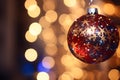 Close-Up of a Sparkling Holiday Ornament Capturing Reflections of Twinkling Lights