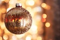 Close-Up of a Sparkling Holiday Ornament Capturing Reflections of Twinkling Lights