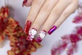 Close up sparkling red color gel polish painting 3D rose flower decorate d with shiny rhinestone