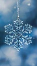 Close-up of a sparkling snowflake ornament with a blurry background