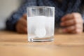 Close up sparkling water glass with dissolving effervescent pill Royalty Free Stock Photo
