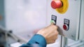 close-up, on a special shield, the hand presses the green start button, next to the red-stop