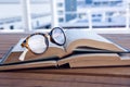 Close-up of spectacles on open book Royalty Free Stock Photo