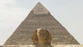 Close up of the sphinx with the pyramid of khafre in the background at giza Royalty Free Stock Photo