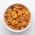 Close-Up of Spicy Chatpata Mixture in a white Ceramic bowl made with peanuts, corn flakes. Indian spicy snacks Namkeen,